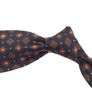 Navy silk foulard tie with green and orange medallion print, hand-rolled & untipped