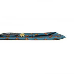 Hand-printed slate blue silk twill tie, rust and olive medallion print
